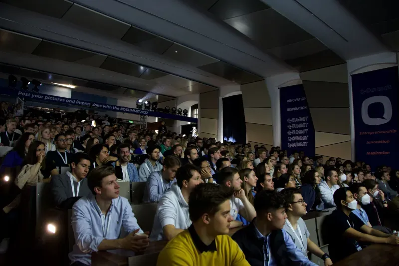 Attendees networking in the crowd at Q-Summit