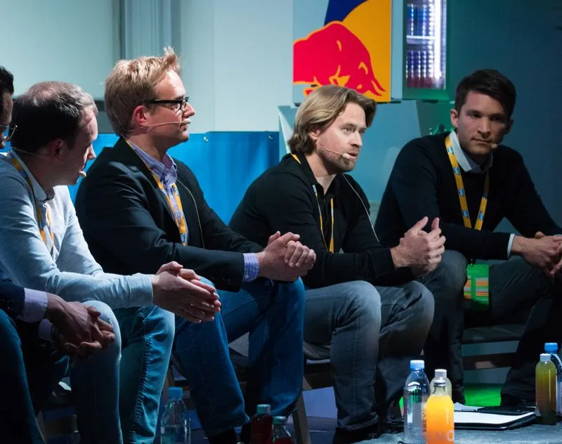 A founder speaking on stage at Q-Summit